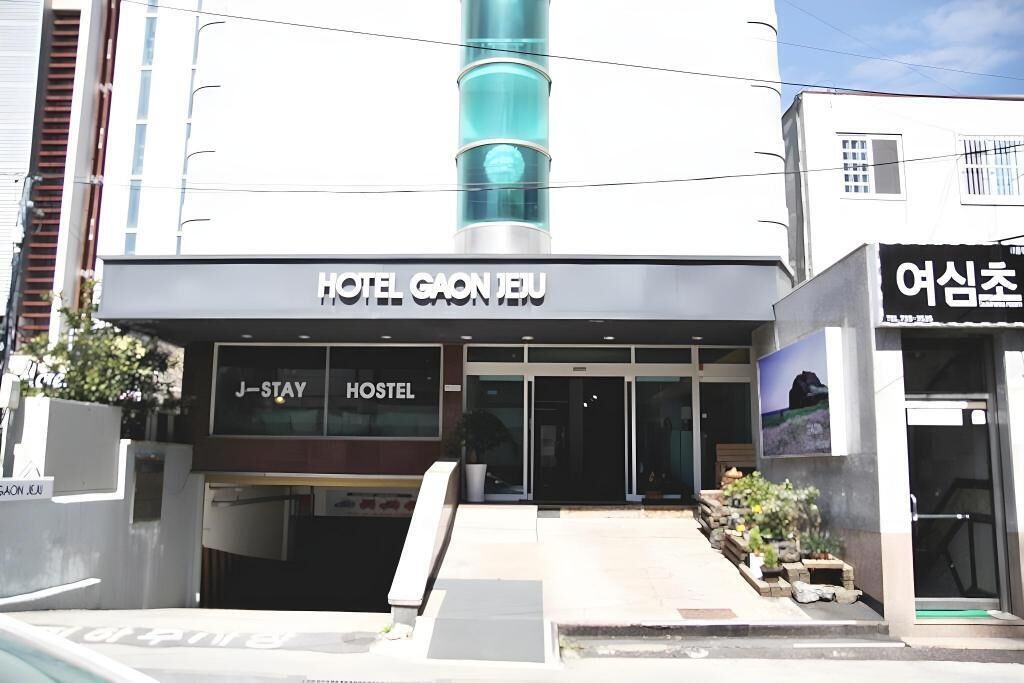 A hotel entrance with a sign reading "HOTEL GAON JEJU" and "J-STAY HOSTEL".