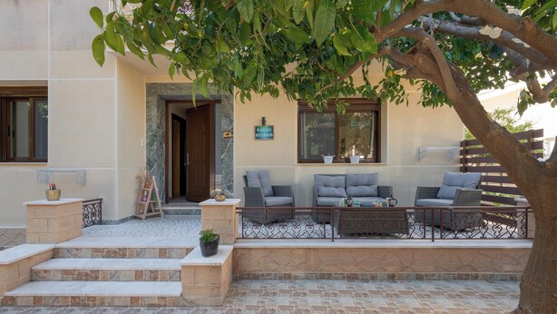 A patio with outdoor seating, steps leading to a door, and a sign reading 'PARRO STUDIO'. - Parko Studios - Studio 1 (Rodos)