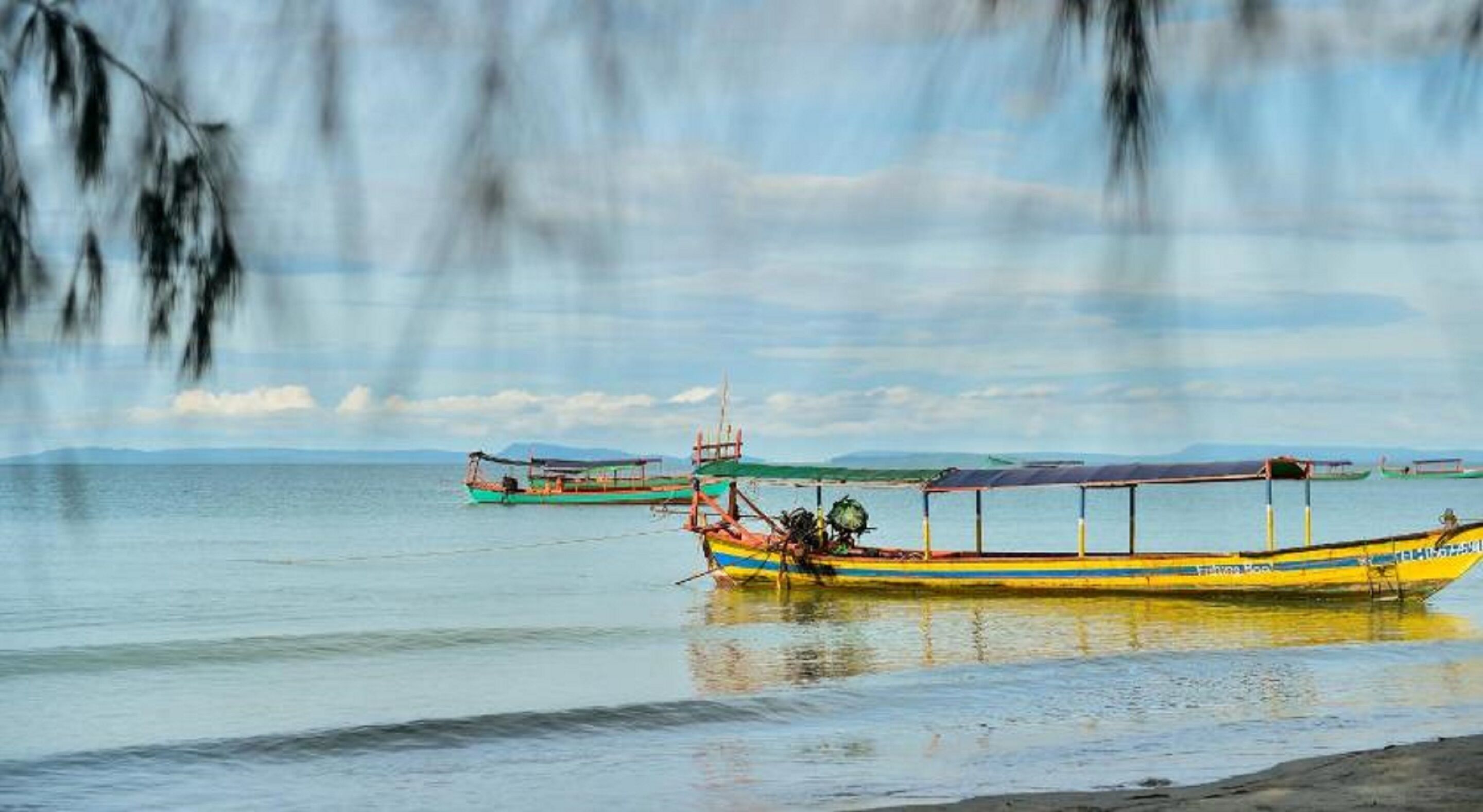 A calm body of water with several boats anchored.