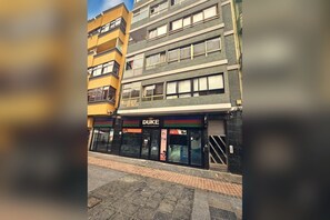 A multi-story building with a storefront labeled 'DUKE' and a sign for 'CYNOSIS GRAPHIC'.