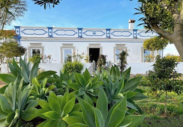 Traditional building with a well-maintained garden.