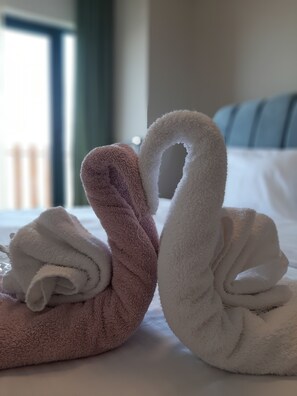 Two towels shaped like swans on a bed. - Furnished Cozy & luxury Flat (Tbilisi)