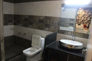 Un baño con inodoro, lavabo y ducha.