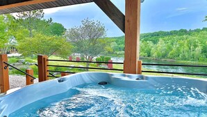 Ein Whirlpool mit Blick auf einen Fluss und grüne Umgebung.