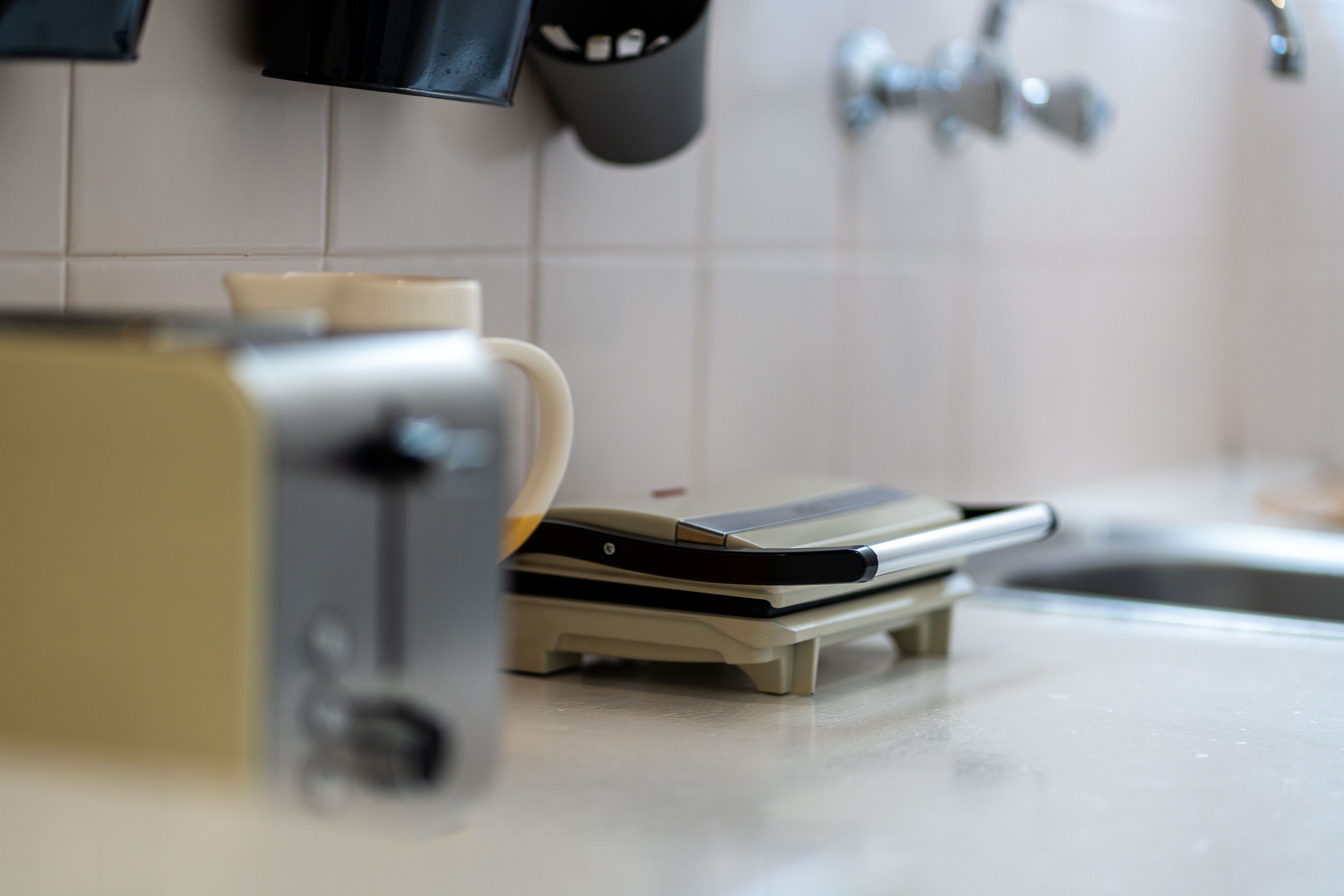 A kitchen with a toaster and a coffee maker on the counter.