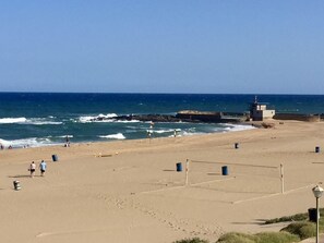 A beach with a lifeguard tower, clear skies, and calm sea. - Family-friendly, sea and breaker view, 2 min from beach (Amanzimtoti)