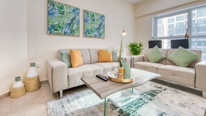 Ein modernes Wohnzimmer mit zwei Sofas, einem Couchtisch und Kunstwerken an der Wand.