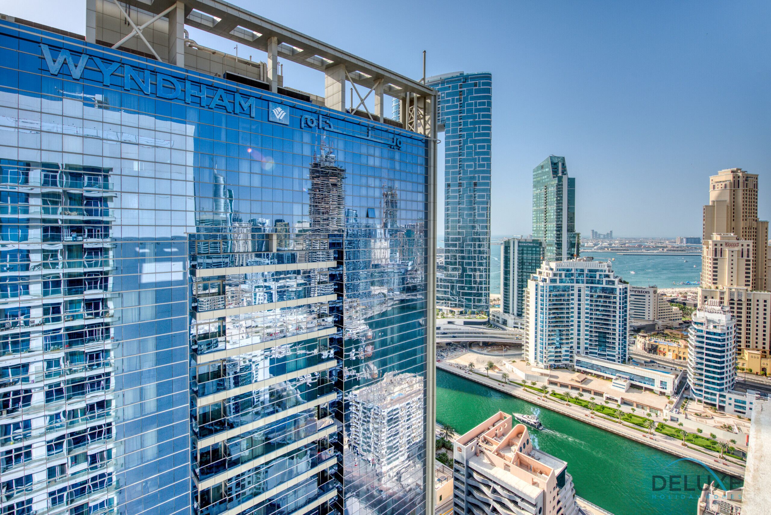 A high-rise building with a glass facade and the name "WYNDHAM" prominently displayed.