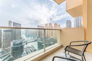 A balcony with a view of a cityscape and a river.