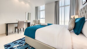 A modern hotel room with a large bed, a desk, and a chair. - Luxury 1BR at DAMAC Celestia A Dubai South by Deluxe Holiday Homes (Dubai)