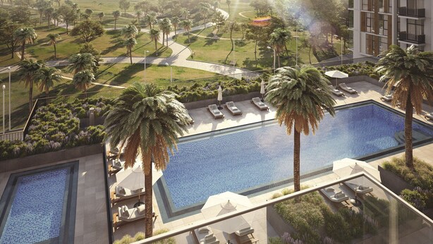 A modern hotel with a rooftop pool, palm trees, and a view of a golf course. - Fresh 2BR at Mudon Views 4 Dubailand by Deluxe Holiday Homes (Dubai)