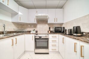 Enjoy cooking in this kitchen with a stainless steel range, oven, microwave, toaster, and coffee maker.