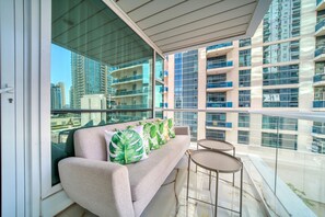 Relax on the balcony with a sofa and table, taking in the view of the city.