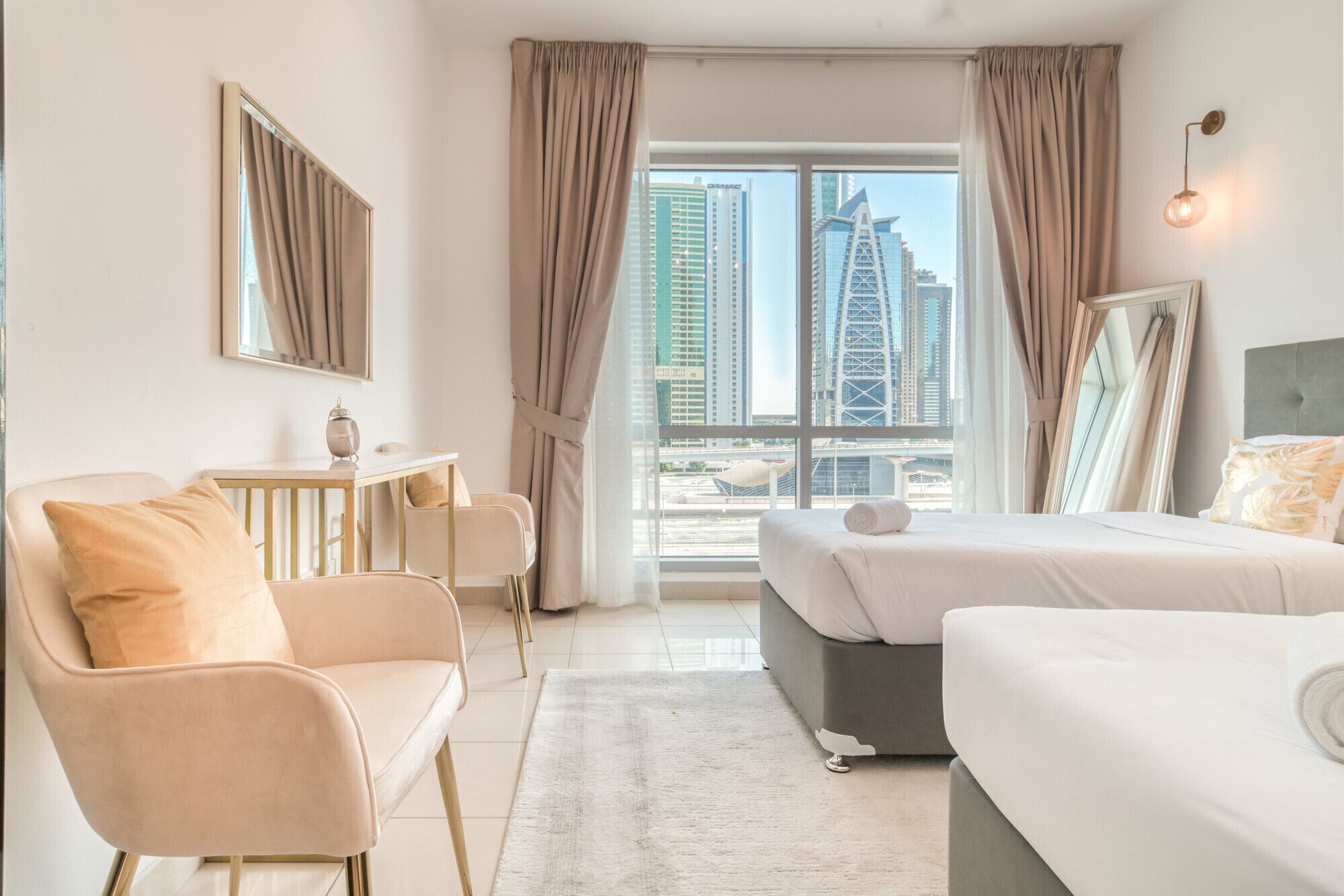 A modern hotel room with a large window, a bed, a desk, and a chair.