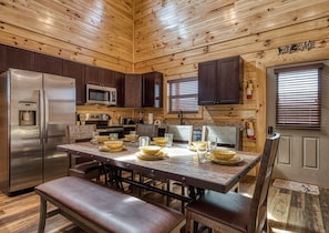 Modern kitchen with water dispenser, coffee maker, and stainless steel appliances.