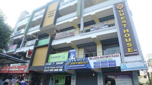 A multi-story building with various commercial establishments including a guest house, a dental clinic, and a medical center. - SK Guest House  (Visakhapatnam)