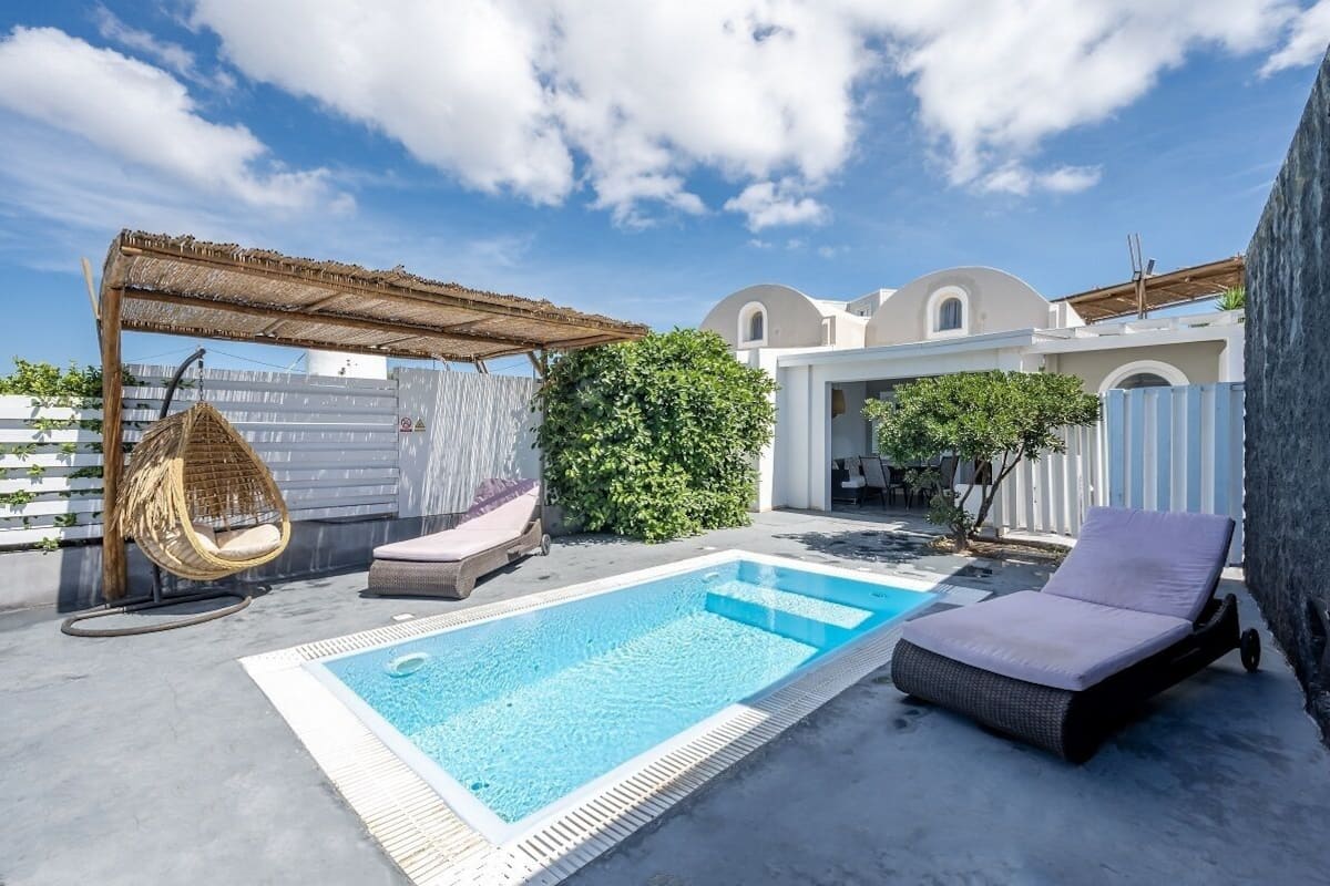 A rooftop pool area with a hanging chair, a lounge chair, and a pergola.