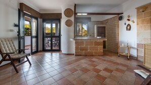 A spacious living area with a large window, a fireplace, and a comfortable seating area.