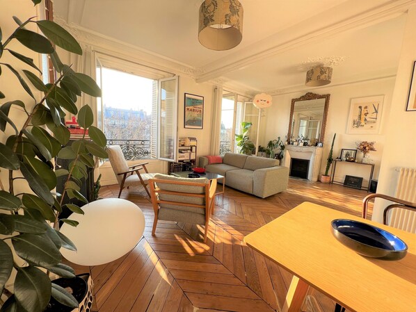 Relax in this stylish living room with a sofa, dining table, and city views.