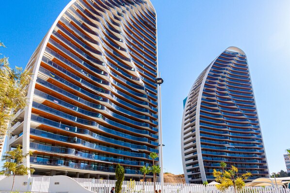 Two modern high-rise buildings with multiple balconies, likely residential or hotel units. - SUNSET WAVES superb apartments (Benidorm)