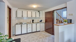 A compact kitchen with white cabinets, a microwave, and a sink. - 2 BR House By The Creek Near Plitvice Lakes (Plitvicka Jezera)