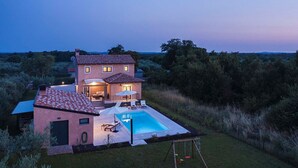 A two-story house with a swimming pool and a swing set in the backyard. - Villa Azur – Private pool, wellness, and spacious garden (Muntic)