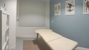 A clinical examination room with a treatment table, a white toilet, and anatomical posters on the wall. - Exclusive room with bathroom - on Metro A line (Roma)