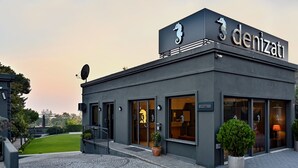 A modern building with a sign reading "denizati" and a seahorse logo. - Denizati Plus Hotel (Istanbul)