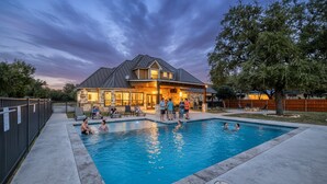 A house with a swimming pool, a covered patio, and a stone exterior. - Tatanka @ Frio Premier Rental Homes (Concan)