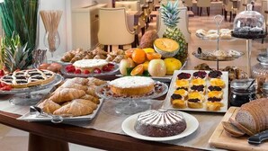 A buffet table with various pastries, fruits, and bread. - Fedora Hotel (Rimini)