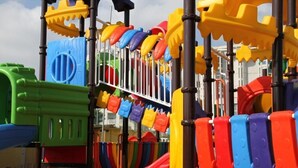 A playground with various colorful play structures including slides and climbing areas. - Fedora Hotel (Rimini)