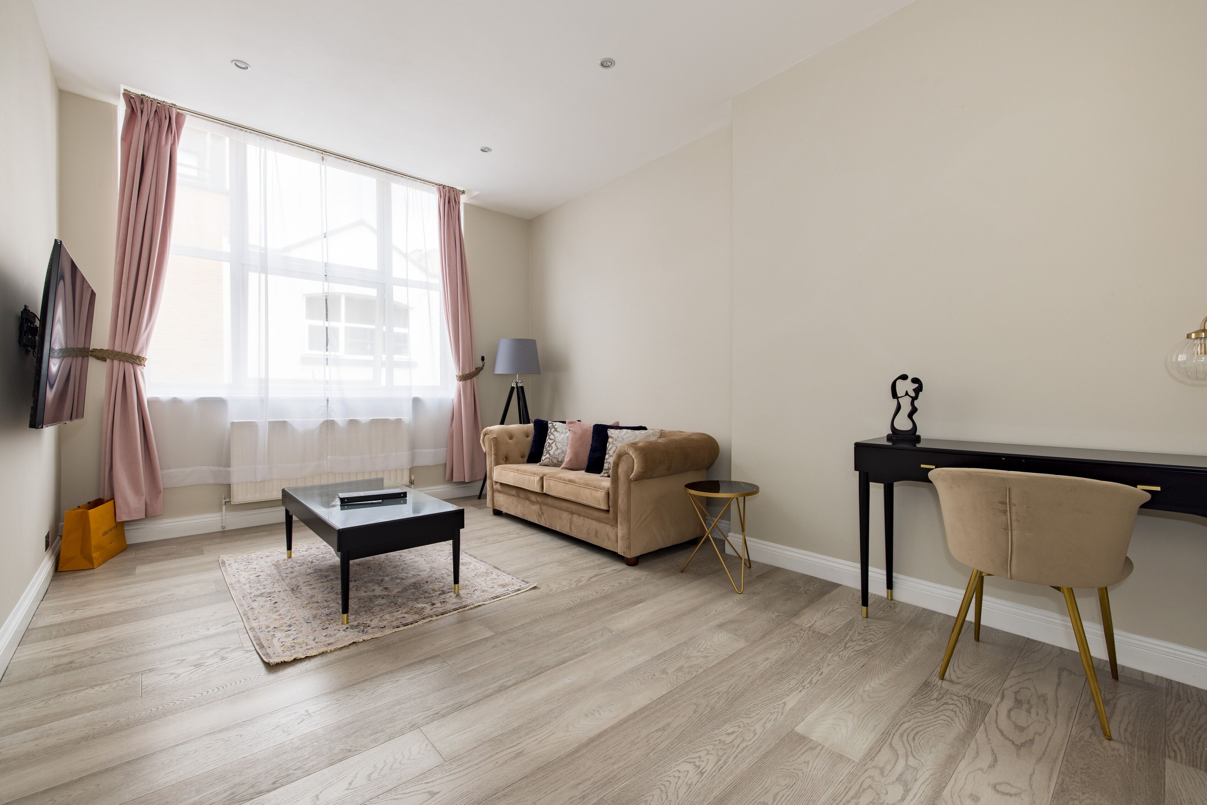 A living room with a sofa, coffee table, and a side table.