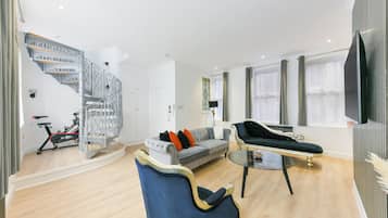 Signature Apartment | Living area | 55-inch Smart TV with digital channels, TV, Netflix