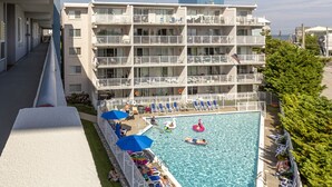 A multi-story hotel with a pool area.