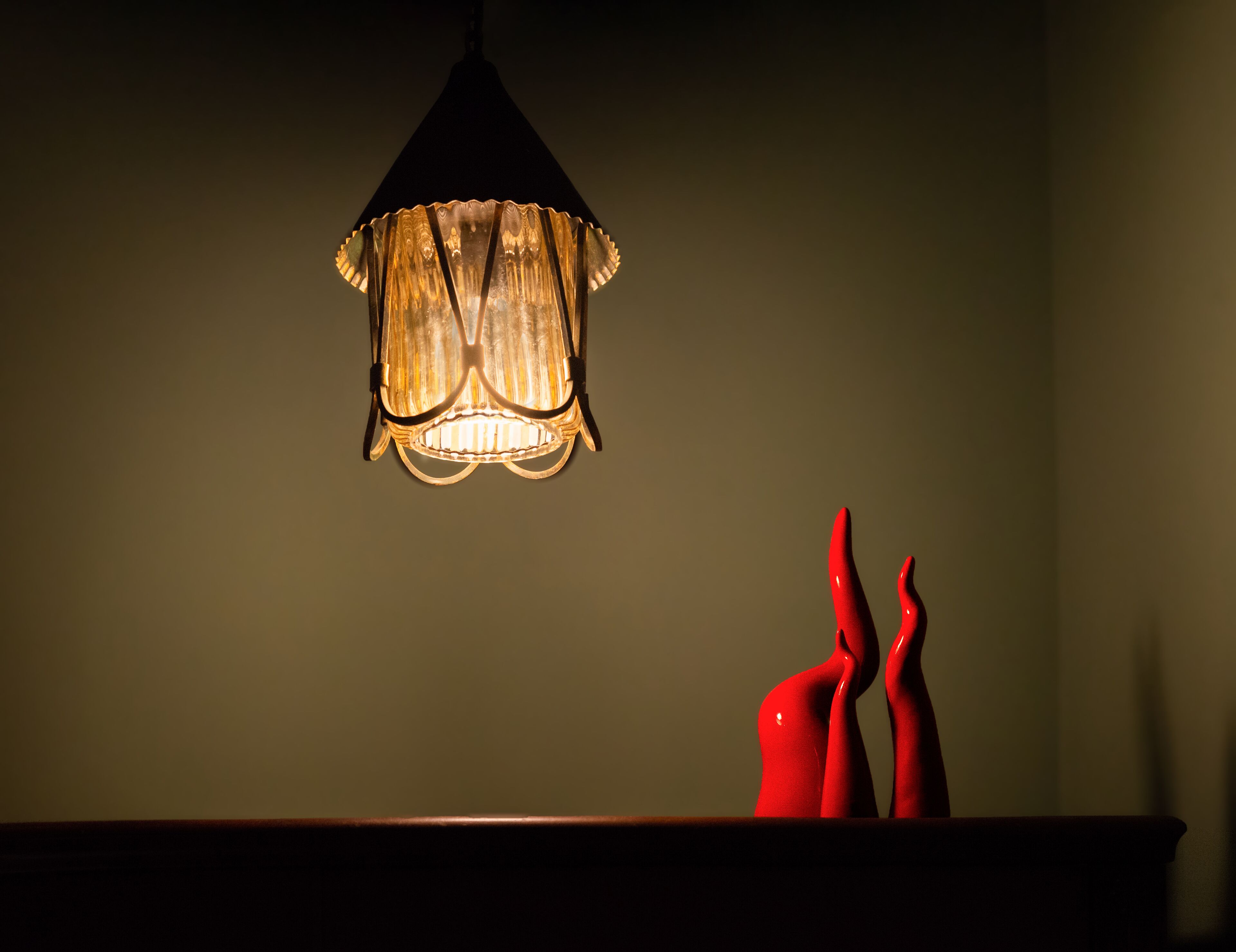 A pendant light with a textured shade hanging from the ceiling.