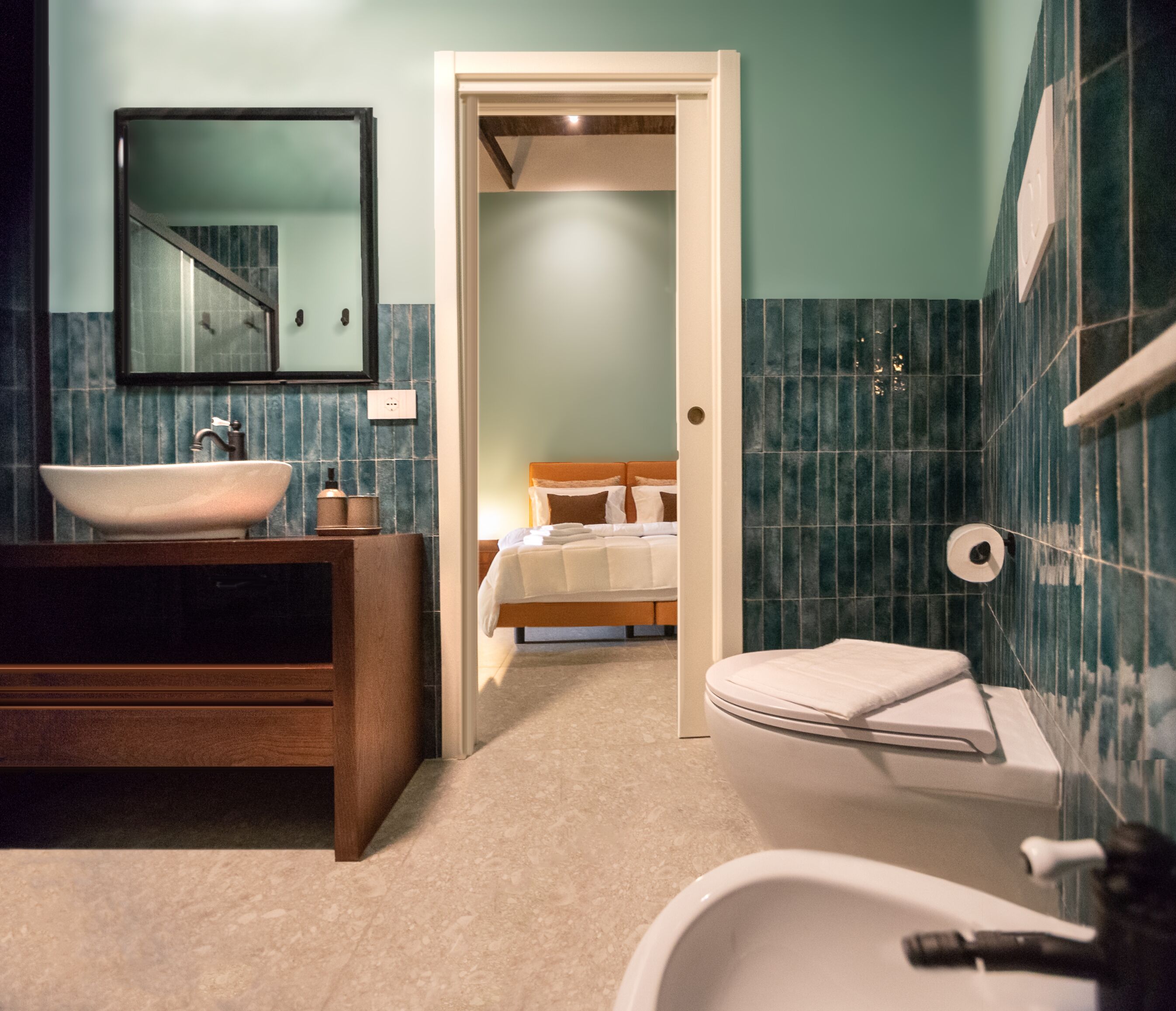 A bathroom with a sink, toilet, and shower area.