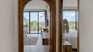 A modern interior with a wooden archway leading to a balcony with a view of palm trees and a distant building. - Villa Nueva Expectacular. Vive Bingin Beach!! Trona, Cuna, Bañera Gratis (Bali)