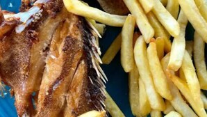 A plate with fried fish, fries, and a lime wedge. - Villa Cruz Hotel & Restaurant Windsurf Fan Eco Rm (buen hombre)