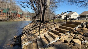 A stone staircase leading down to a river, surrounded by rocks and trees. - River Bear-Riverfront in Pigeon Forge (Pigeon Forge)