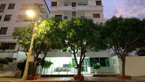A multi-story building with a modern architectural style, featuring balconies and large windows. - Hotel Rodadero Inn By GEH Suites (Santa Marta)
