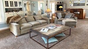 A spacious living room with two sofas, a coffee table, and a fireplace. - BY THE BAY (Annapolis)