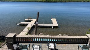 A lakeside dock with a wooden pier, a bench, and a stone railing. - Deepwater Lodge Chicagon Lake- Sleeps 24-Pontoon included-DM for June specials! (Crystal Falls)
