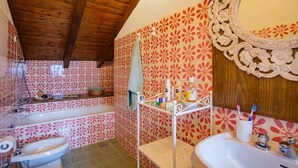 A bathroom with a wooden ceiling, a large mirror, and a sink with a towel rack. - The mountain loft with the most beautiful park on Lake Maggiore as its garden (TRAREGO VIGGIONA)