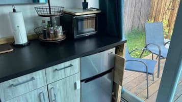 Fridge, microwave, coffee/tea maker, cookware/dishes/utensils