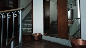 A staircase with a metal handrail, a stone wall, and a wooden door. - Ursula House - Your Mountain Holiday (Premana)