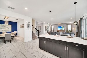 Enjoy a spacious open-plan living area with a large kitchen, dining space, and comfortable seating.