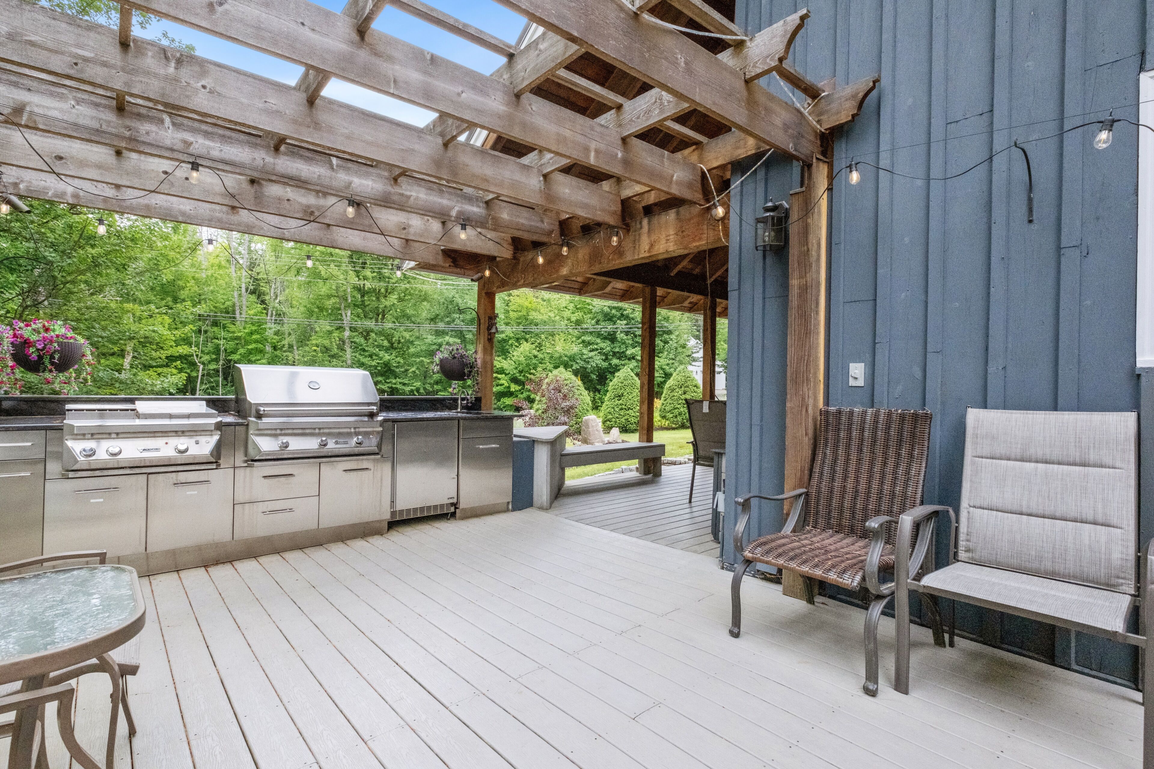 Outdoor kitchen with grill, sink, and mini fridge
