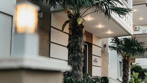 A building with a balcony, a palm tree, and a railing. - Angela Rooms (Dio-Olympos)