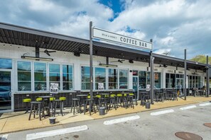 A coffee bar with outdoor seating and a covered area.