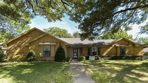 A two-story house with a front lawn, a pathway leading to the front door, and a mailbox. - Sprawling Ranch Home (Fort Worth)